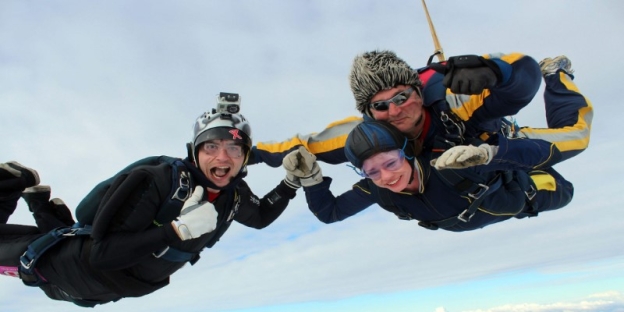 A group of people skydiving AI-generated content may be incorrect.